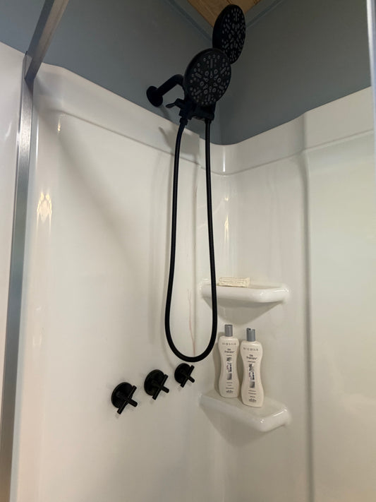 Matte black 3-handle shower system installed in Better Within guest bathroom